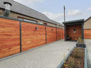 a wooden fence in front of a house at The Dance Hall at The Institute Executive Apartments in Keith