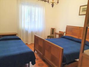 Postel nebo postele na pokoji v ubytování Hotel Madonna di Luciago