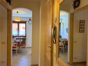 a hallway leading to a dining room with a table at Casa Orchidea Bianca by Holiday World in Limone Piemonte