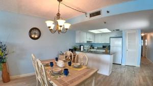 a dining room and kitchen with a table and chairs at Sea Club Condo #304 in Clearwater Beach