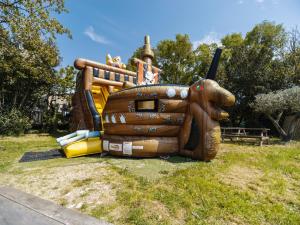a large inflatable play structure in a park at Camping Paradis 4 étoiles Au Port de L'Houmeau - La Rochelle in LʼHoumeau