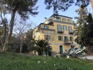 a yellow house with a palm tree in front of it at Villa9centob&b in Castel di Lama
