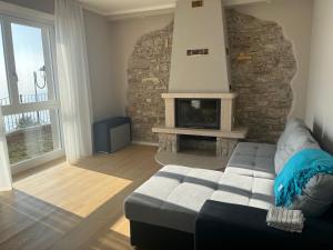 a living room with a couch and a fireplace at Villa Belvedere in Gargnano