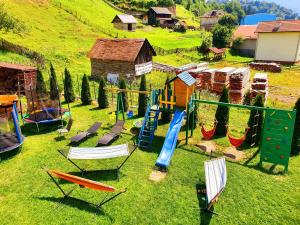 an aerial view of a playground with chairs and slides at Casa Teodor Rucăr Casă de oaspeți in Rucăr