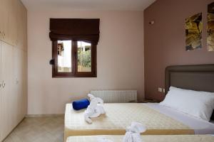 Postel nebo postele na pokoji v ubytování Villas Roumeli
