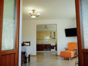 a living room with a table and a chair at Villa Med'OK in Vyzhnytsya