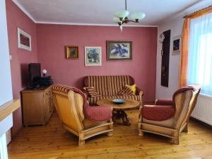 a living room with two chairs and a table at Cottage next Svihov castle in Švihov