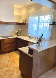 a kitchen with a bottle of wine on a counter at Villa PALMERA in Sant Jordi