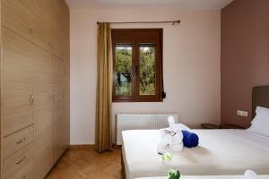 Postel nebo postele na pokoji v ubytování Villas Roumeli