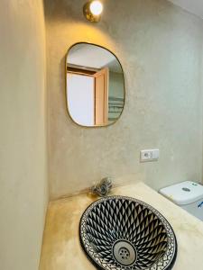 y baño con lavabo y espejo. en Riad Yu Yu, en Marrakech
