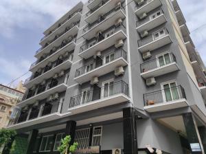 a white apartment building with balconies at Hotel Lido in Athens