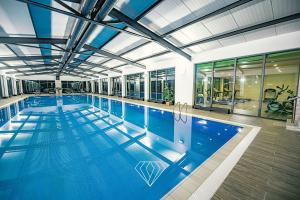 a large swimming pool in a large building at Bakuriani Crystal Loft 412 in Bakuriani