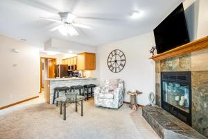a living room with a fireplace and a tv at Lighthouse Cove Condo Resort in Wisconsin Dells
