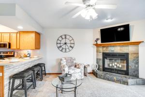 a kitchen and living room with a fireplace at Lighthouse Cove Condo Resort in Wisconsin Dells