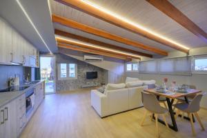 a kitchen and living room with a couch and a table at Contemporary Attic in Preveza