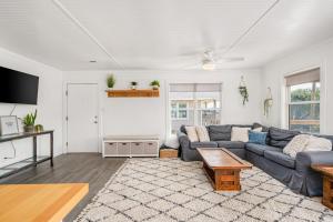a living room with a couch and a table at Offshore Winds - KDH112 in Kill Devil Hills