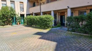 a cobblestone street in front of a building at Fiorilli House - Fair District - Gratis Private Parking in Bologna