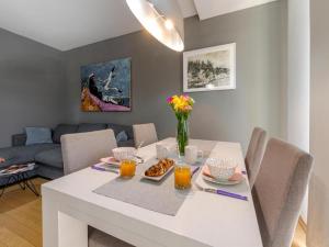 a dining room with a white table with food on it at Apartment Corto Maltese in Dubrovnik
