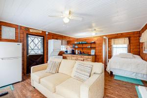 a living room with a couch and a bed at Cozy Cabin in Sevierville