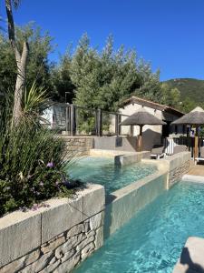 a swimming pool in a backyard with a resort at Camping de la Treille in Cavalaire-sur-Mer