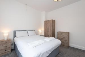 a bedroom with a large white bed with two night stands at Teal Road in Darlington