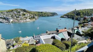 a view of a river with boats in a town at Out To Sea - Stunning views, elevated position with onsite parking in Dartmouth