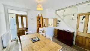 a kitchen and dining room with a wooden table at Out To Sea - Stunning views, elevated position with onsite parking in Dartmouth