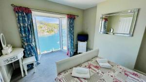 a bedroom with a bed and a view of the ocean at Out To Sea - Stunning views, elevated position with onsite parking in Dartmouth