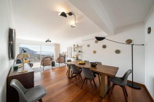 a kitchen and dining room with a table and chairs at Casa do Castelo by An Island Apart in Funchal