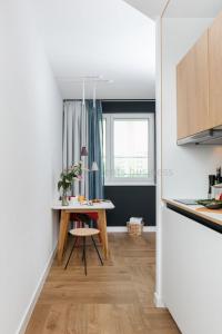 a small kitchen with a table and a window at SMARTments business Berlin Prenzlauer Berg in Berlin