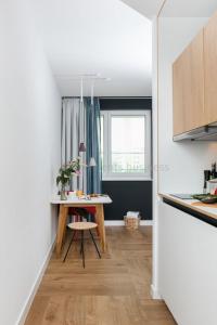 a small kitchen with a table and a window at smartments Berlin Prenzlauer Berg in Berlin