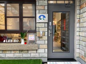 a black door on a building with a store at LeeHo B&B 李何寓所 in Hualien City