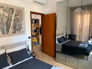 a bedroom with a bed and a glass door at Pisa City Home in Pisa
