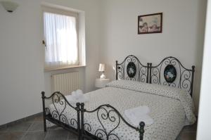 a bedroom with a black bed with a white comforter at FONTE D'OLIO CONERO RELAIS in Sirolo