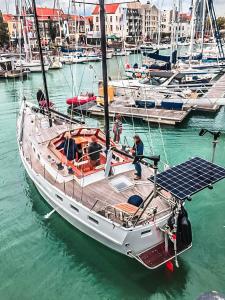 a sailboat is docked in a harbor with other boats at Zeilschip Lucia in Vlissingen