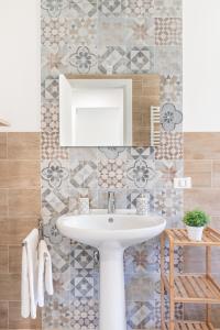 a bathroom with a sink and a mirror at Villa Costamante con piscina privata in Balata di Baida