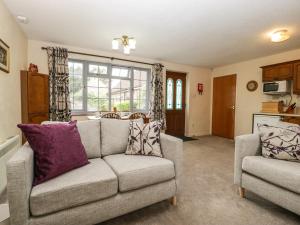 a living room with a couch and a chair at Owls Retreat in Weston-super-Mare