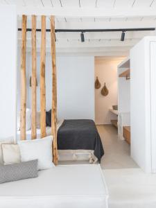 a bedroom with a swing and a bed at Karai, The House Project in Astypalaia Town