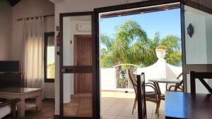 a room with a door open to a patio with a table at Apartamentos Hacienda Sajorami in Zahora