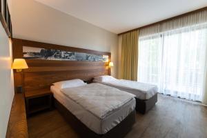 Postelja oz. postelje v sobi nastanitve Hotel Arena Maribor