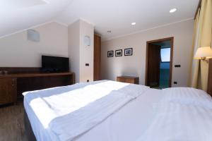 Postelja oz. postelje v sobi nastanitve Hotel Arena Maribor