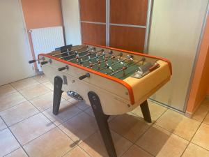 a foosball table sitting on top of a floor at Chambre d'hôtes Les Grillons in Olemps