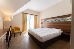 Postelja oz. postelje v sobi nastanitve Hotel Arena Maribor