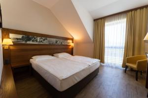 Postelja oz. postelje v sobi nastanitve Hotel Arena Maribor