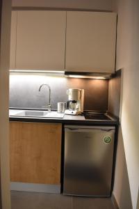 a small kitchen with a sink and a stove at Studio2 in Katerini in Katerini