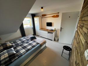 a bedroom with a bed and a desk in it at Sun & Fun in Władysławowo