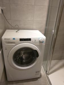 a washing machine in a corner of a room at Kavadias Apartments in Vasiliki