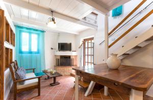 a dining room with a wooden table in a room at Restored Historic Mansion Paterno with Exclusive Pool, Wifi and AC for 20 people in Alghero