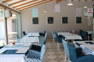 a dining room with tables and blue chairs at Casablanca Hotel in Dalyan