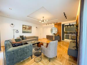 a living room with a couch and a table at B&B Lovac Pool & Spa in Ulcinj
